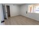 A spacious bedroom with modern flooring, a window, and new paint at 7811 N 46Th Ave, Glendale, AZ 85301