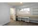Bedroom featuring built-in shelving, a window desk, and modern flooring at 7811 N 46Th Ave, Glendale, AZ 85301