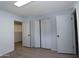 Bright bedroom featuring closet with bifold doors and updated flooring at 7811 N 46Th Ave, Glendale, AZ 85301