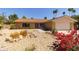 Charming single-story home featuring desert landscaping, including rocks, cacti, and vibrant bougainvillea at 7811 N 46Th Ave, Glendale, AZ 85301