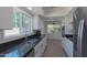 Well-lit kitchen with granite countertops and modern appliances providing a functional cooking space at 7811 N 46Th Ave, Glendale, AZ 85301