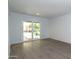 Bright room with wood-look floors and sliding glass doors to covered patio at 7811 N 46Th Ave, Glendale, AZ 85301