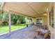 Covered patio with outdoor seating overlooking a manicured backyard and garden at 7811 N 46Th Ave, Glendale, AZ 85301
