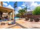 Spacious backyard with an inviting pool, outdoor seating, a patio with ceiling fan, and a basketball court at 8341 W Palo Verde Ave, Peoria, AZ 85345