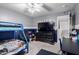 Bedroom featuring a blue bunk bed, desk, television, and ceiling fan at 8341 W Palo Verde Ave, Peoria, AZ 85345