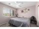 Bedroom with a window providing natural light, carpet flooring, and a ceiling fan at 8341 W Palo Verde Ave, Peoria, AZ 85345