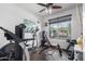 Bright workout area with a variety of exercise equipment and a large window offering plenty of natural light at 8341 W Palo Verde Ave, Peoria, AZ 85345