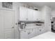 Bright kitchen features white cabinets, a mosaic tile backsplash, and white countertops at 8341 W Palo Verde Ave, Peoria, AZ 85345
