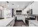 Bright kitchen boasts white cabinets, stainless appliances, an island with pendant lighting at 8341 W Palo Verde Ave, Peoria, AZ 85345