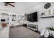 Modern living area with large screen television and views into other living spaces at 8341 W Palo Verde Ave, Peoria, AZ 85345