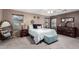 Comfortable main bedroom with neutral tones, carpet floors, ceiling fan and natural light at 8341 W Palo Verde Ave, Peoria, AZ 85345