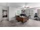 Spacious home office with large desk, ceiling fan, and comfortable desk chair at 8341 W Palo Verde Ave, Peoria, AZ 85345