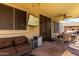 Outdoor patio with comfortable wicker furniture and a ceiling fan, perfect for relaxing and entertaining at 8341 W Palo Verde Ave, Peoria, AZ 85345