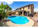 A sparkling blue swimming pool with lush landscaping and patio area, ideal for relaxation and entertaining at 8341 W Palo Verde Ave, Peoria, AZ 85345