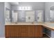 Bathroom with dual sinks, wood cabinetry, and large mirrors at 10136 E Southern Ave # 1074, Mesa, AZ 85209