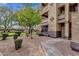 Exterior shot of a building entrance highlighting a well-kept garden and walkway at 10136 E Southern Ave # 1074, Mesa, AZ 85209