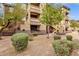 Attractive exterior of a multi-story building with well maintained landscaping, manicured bushes and decorative gravel at 10136 E Southern Ave # 1074, Mesa, AZ 85209