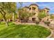 Well-maintained building exterior featuring manicured landscaping and lush green grass at 10136 E Southern Ave # 1074, Mesa, AZ 85209