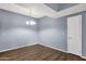A well lit dining room with modern chandelier and wood-look floors at 10136 E Southern Ave # 1074, Mesa, AZ 85209