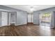 Spacious living room with wood-look flooring, bright natural light, and a sliding glass door at 10136 E Southern Ave # 1074, Mesa, AZ 85209