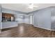 View of an open living space with kitchen, wood-look floors, and a ceiling fan at 10136 E Southern Ave # 1074, Mesa, AZ 85209