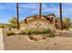 Monument sign at Coyote Landing Condominiums with desert landscaping and mature palm trees at 10136 E Southern Ave # 1074, Mesa, AZ 85209