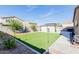 Spacious backyard featuring artificial grass, a gazebo, and mature landscaping at 10138 W Wood St, Tolleson, AZ 85353