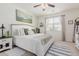 Serene bedroom with a king bed, neutral decor, and a bright window with sheer curtains at 10138 W Wood St, Tolleson, AZ 85353