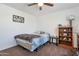 Bedroom with ceiling fan, warm brown carpet, and a shelving unit for storage at 10221 W Puget Ave, Peoria, AZ 85345