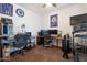 Functional bedroom with multiple monitors, a comfortable chair, and workout equipment creating a multipurpose space at 10221 W Puget Ave, Peoria, AZ 85345