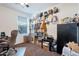 Inviting carpeted bedroom with a cozy chair, window, and shelves at 10221 W Puget Ave, Peoria, AZ 85345