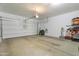 Spacious two car garage with a white door, concrete floor and ample storage space at 10221 W Puget Ave, Peoria, AZ 85345