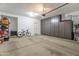 Large garage with ample storage space, overhead lighting and extra built-in cabinets at 10221 W Puget Ave, Peoria, AZ 85345