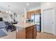 Open kitchen with stainless steel refrigerator, wood cabinets, island, and adjacent dining area at 10221 W Puget Ave, Peoria, AZ 85345