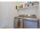 Laundry room with front loading washing machine and dryer with storage shelf above at 10221 W Puget Ave, Peoria, AZ 85345