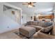 Bright, open-concept living room and kitchen featuring a large sectional sofa and staircase to the upper level at 10221 W Puget Ave, Peoria, AZ 85345