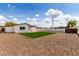 Picture of a backyard with gravel landscaping, privacy fence, and blue skies at 1038 N 78Th Pl, Scottsdale, AZ 85257