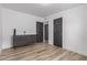 Bedroom with wood-look flooring, a modern dresser, doors, and ample natural light at 1038 N 78Th Pl, Scottsdale, AZ 85257