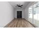 Bright bedroom with ceiling fan, closet and access to the backyard through sliding glass doors at 1038 N 78Th Pl, Scottsdale, AZ 85257