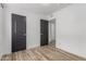Spacious bedroom with wood-look flooring, featuring doors and neutral wall colors at 1038 N 78Th Pl, Scottsdale, AZ 85257