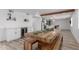 Open dining space with rustic wood table, bar and kitchen in the background at 1038 N 78Th Pl, Scottsdale, AZ 85257