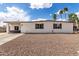 Charming single-story home with a low-maintenance rock front yard and white exterior paint under a clear sky at 1038 N 78Th Pl, Scottsdale, AZ 85257