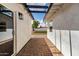 A covered breezeway with brick flooring, connecting two sections of a house at 1038 N 78Th Pl, Scottsdale, AZ 85257