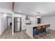 Bright kitchen with white cabinets, stainless steel appliances, and island seating at 1038 N 78Th Pl, Scottsdale, AZ 85257