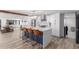 Open kitchen with a waterfall island, stainless appliances, and wood-look floors at 1038 N 78Th Pl, Scottsdale, AZ 85257