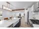 Kitchen island with white marble countertop, farmhouse sink, and seating at 1038 N 78Th Pl, Scottsdale, AZ 85257