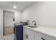 Laundry area equipped with modern appliances, a sink, and stylish patterned flooring at 1038 N 78Th Pl, Scottsdale, AZ 85257