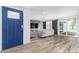Bright living room with wood-look flooring and modern decor including shiplap wall and sliding barn door at 1038 N 78Th Pl, Scottsdale, AZ 85257