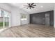 Bright living room with a ceiling fan, wood-look floors, and accent wall at 1038 N 78Th Pl, Scottsdale, AZ 85257