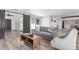 Bright living room featuring a modern gray sofa and stylish decor leading to dining area at 1038 N 78Th Pl, Scottsdale, AZ 85257